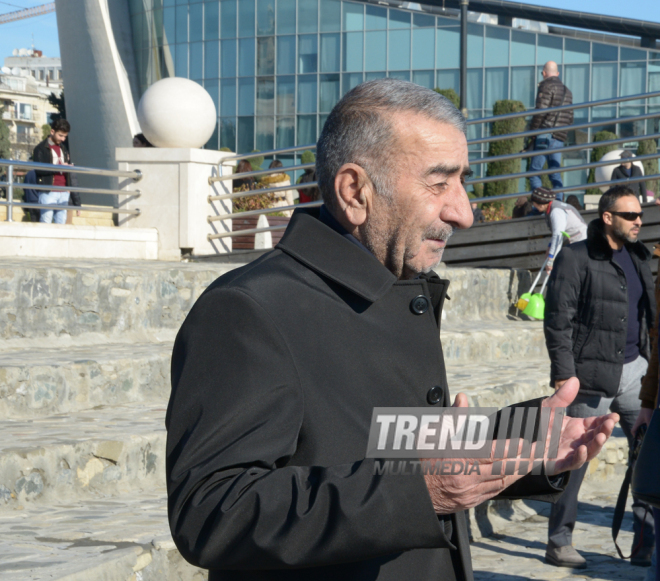 Baku residents bringing flowers to Seaside Boulevard to honor missing oil workers.  Azerbaijan, Dec.07, 2015